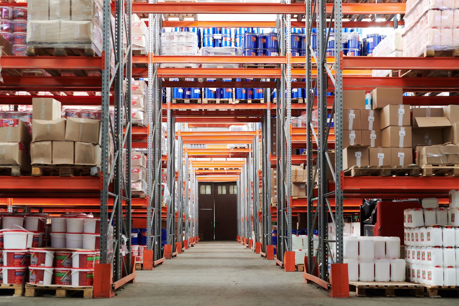 Autonomous mobile robot moving through a warehouse aisle
